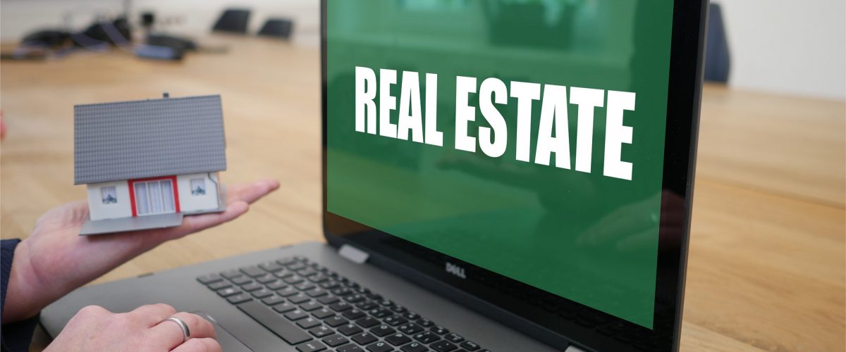 An open laptop sitting on top of a wooden table