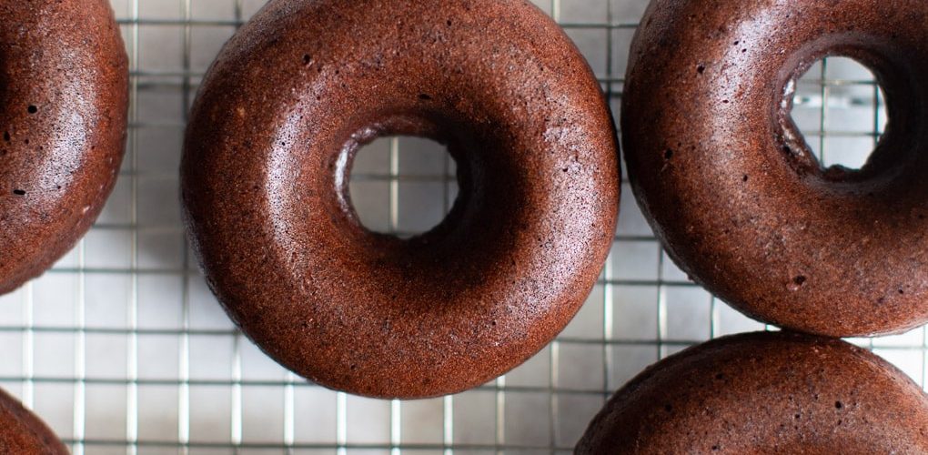A doughnut sitting on a tiled floor