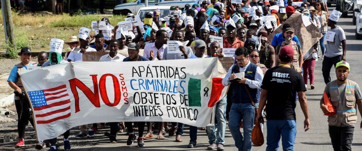 A group of people riding on the back of a truck
