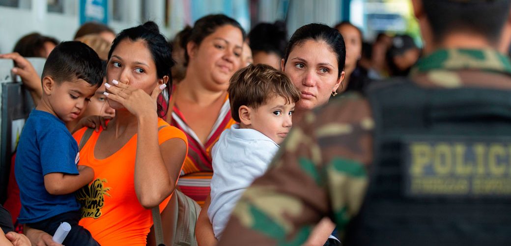 A young boy standing in front of a crowd